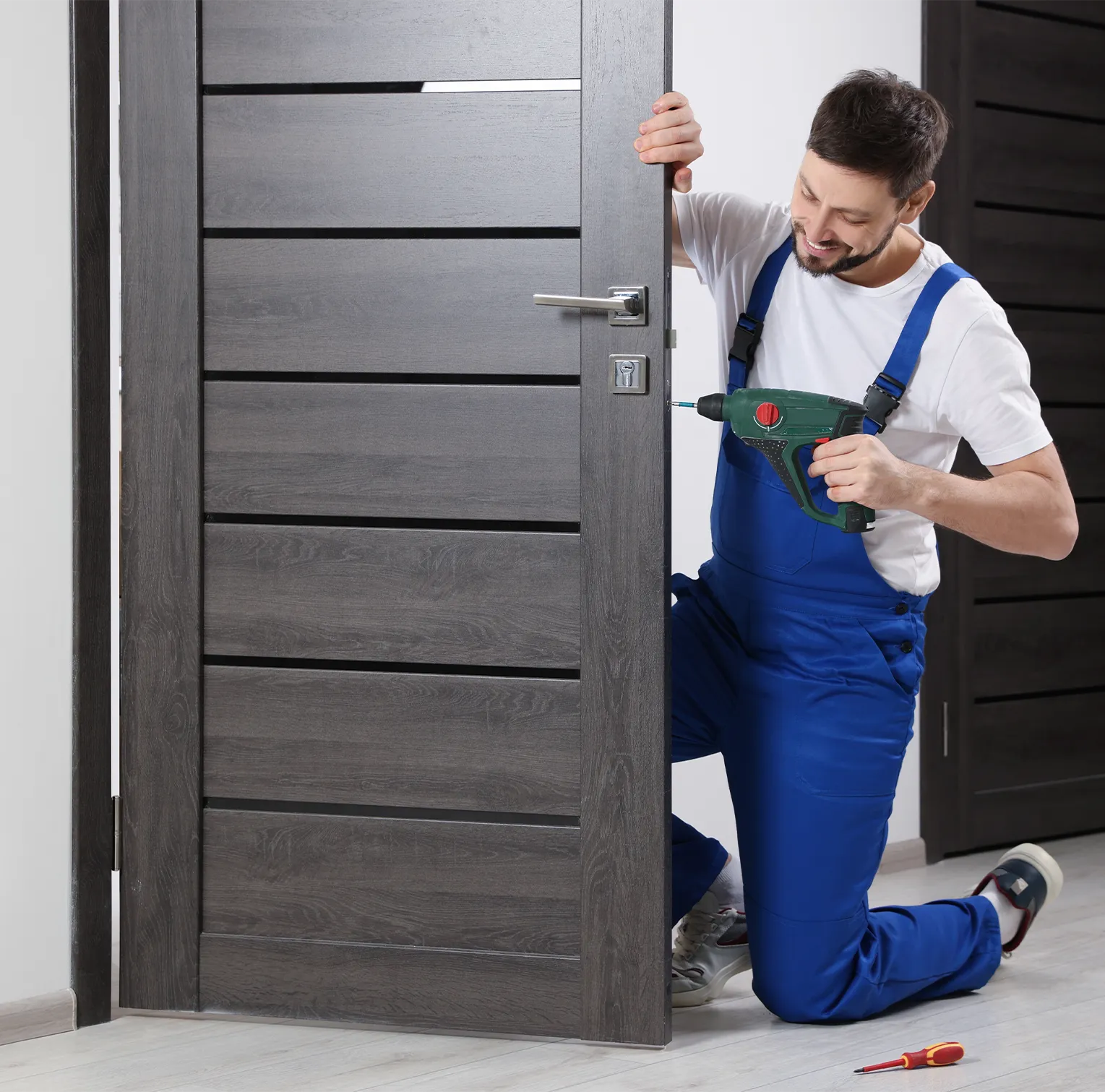 service-man-installing-door-hinge Service man installing door hinge